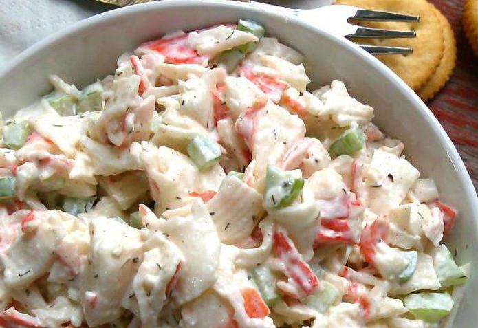 Simple salads with crab sticks, tomatoes and cheese